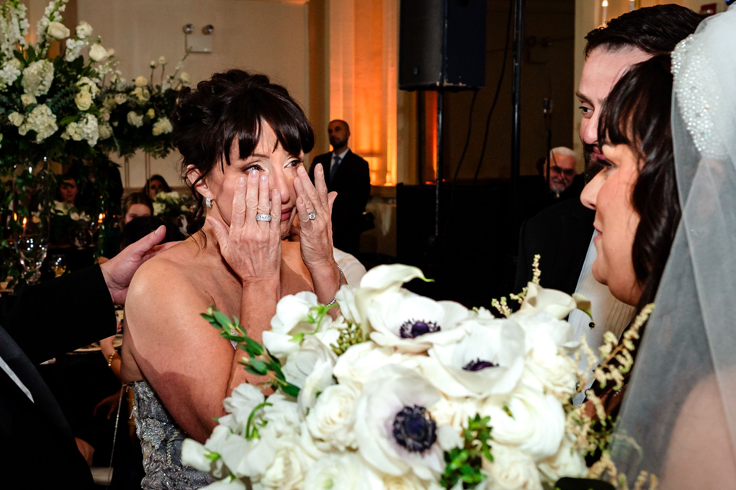 White floral arrangements and wedding decor details at reception venue.