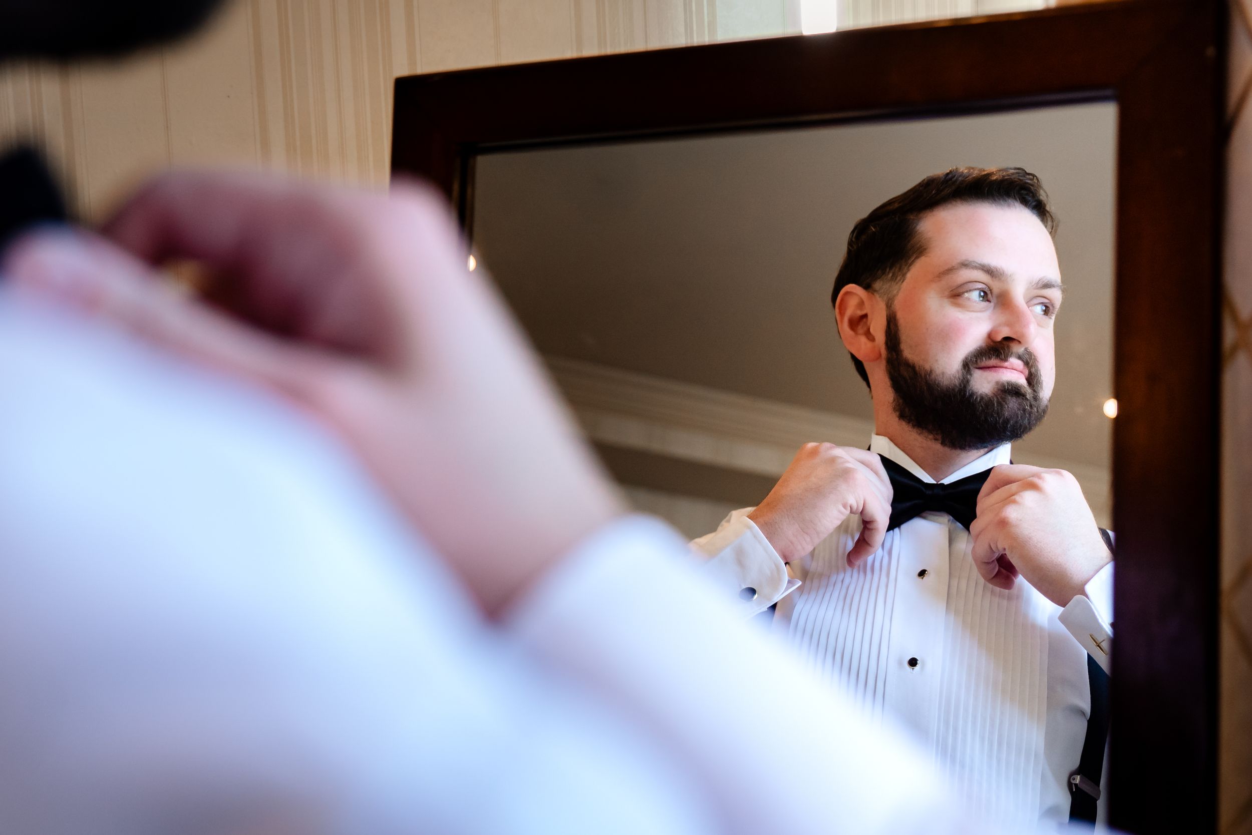 Close-up shots of formal attire preparation before the wedding ceremony.