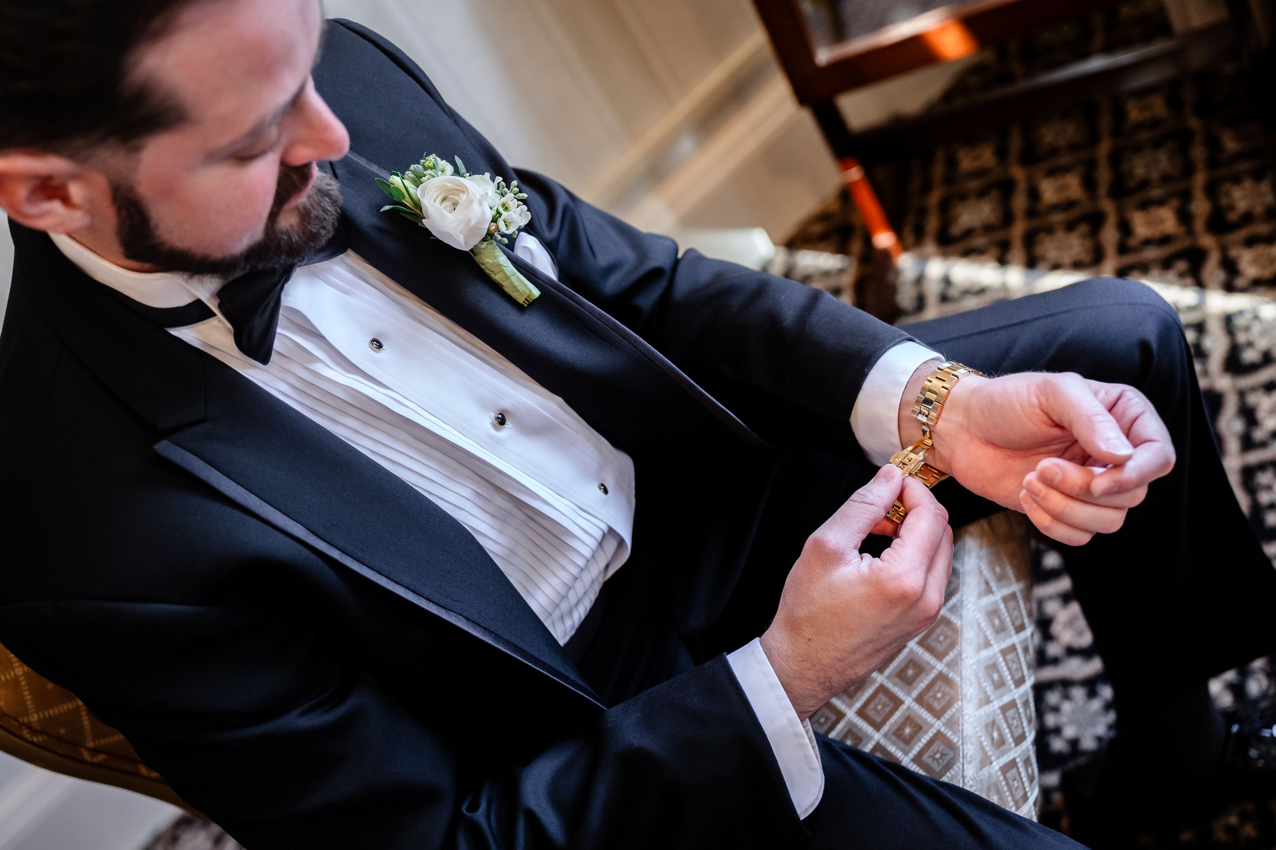 Close-up view of hands exchanging wedding rings during traditional ceremony.