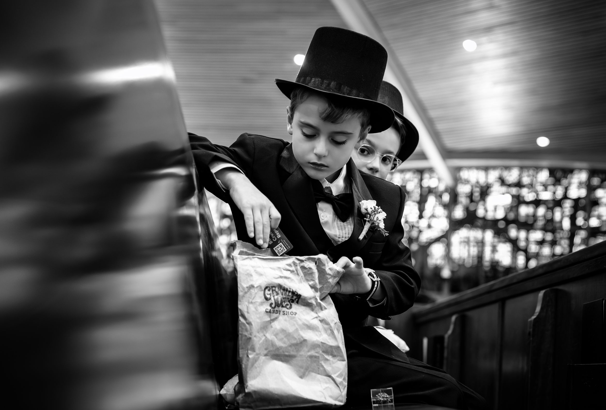 Black and white images of young guests at a wedding ceremony.