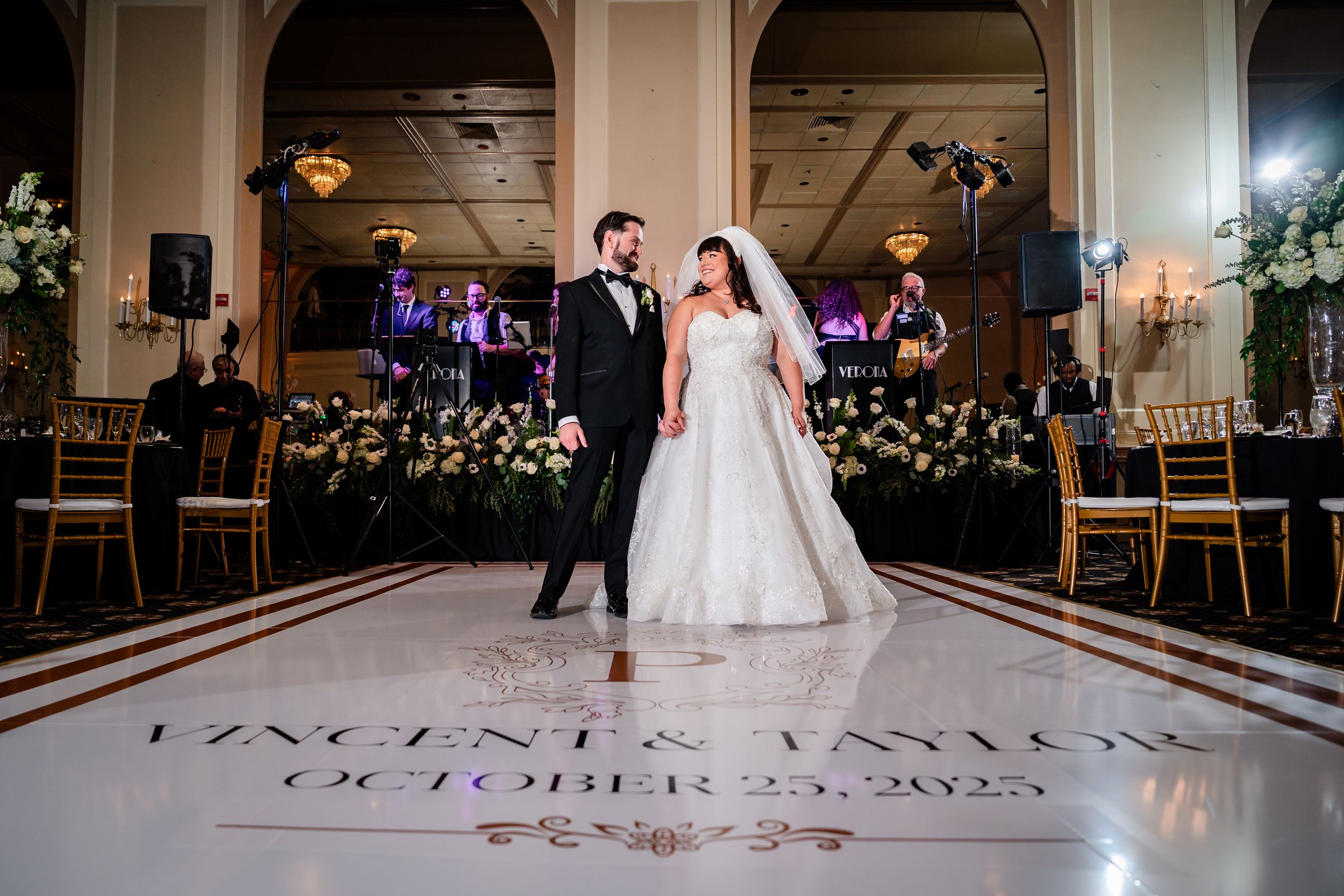 Elegant wedding reception venue with arched doorways and decorative lighting creating a romantic atmosphere.