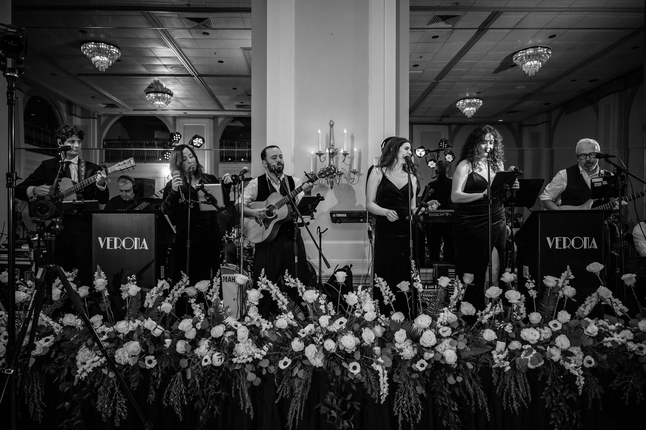 Overhead view of a large wedding reception with guests seated at round tables in an elegant ballroom.