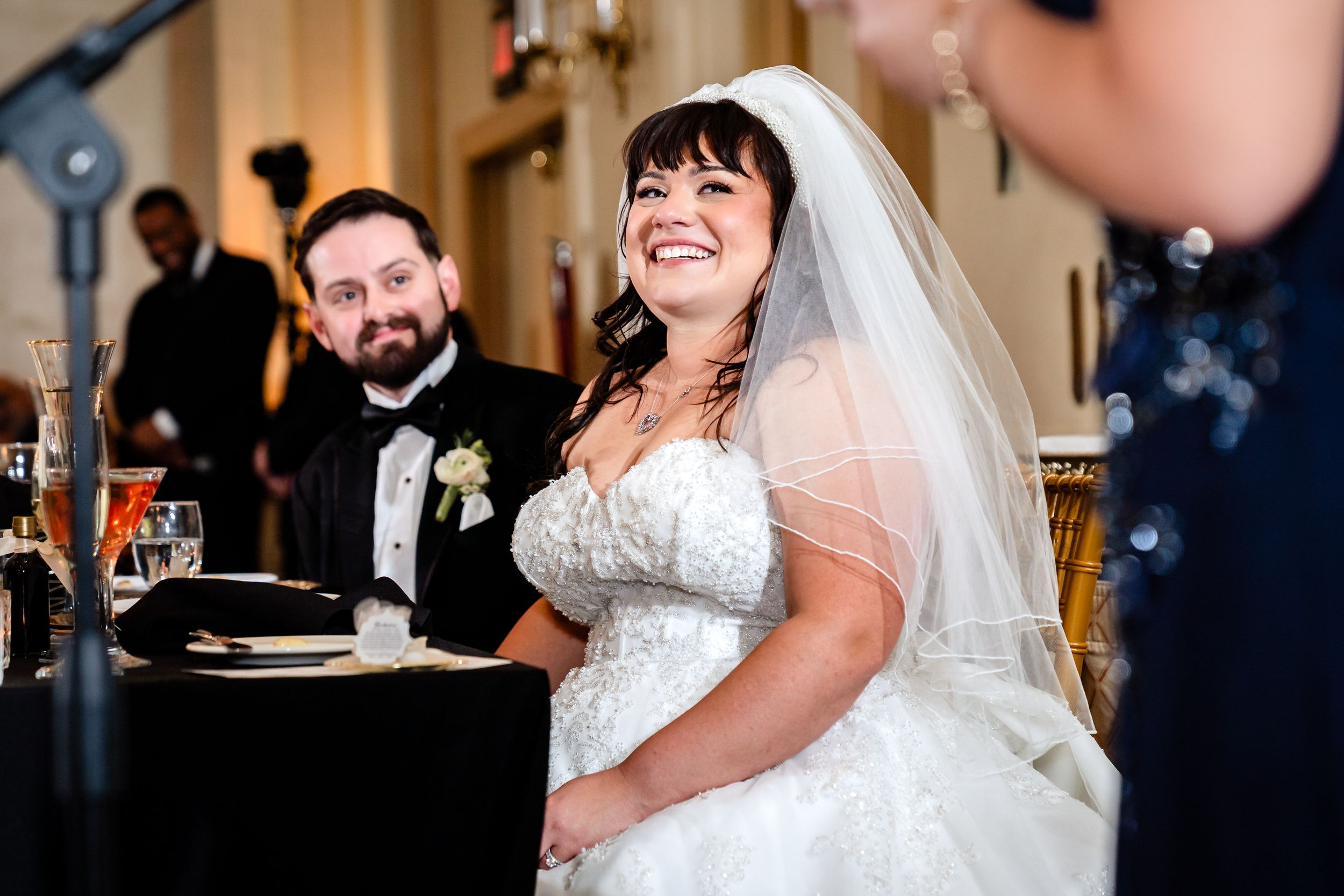 Wedding celebration in an elegant ballroom with warm lighting and festive atmosphere.