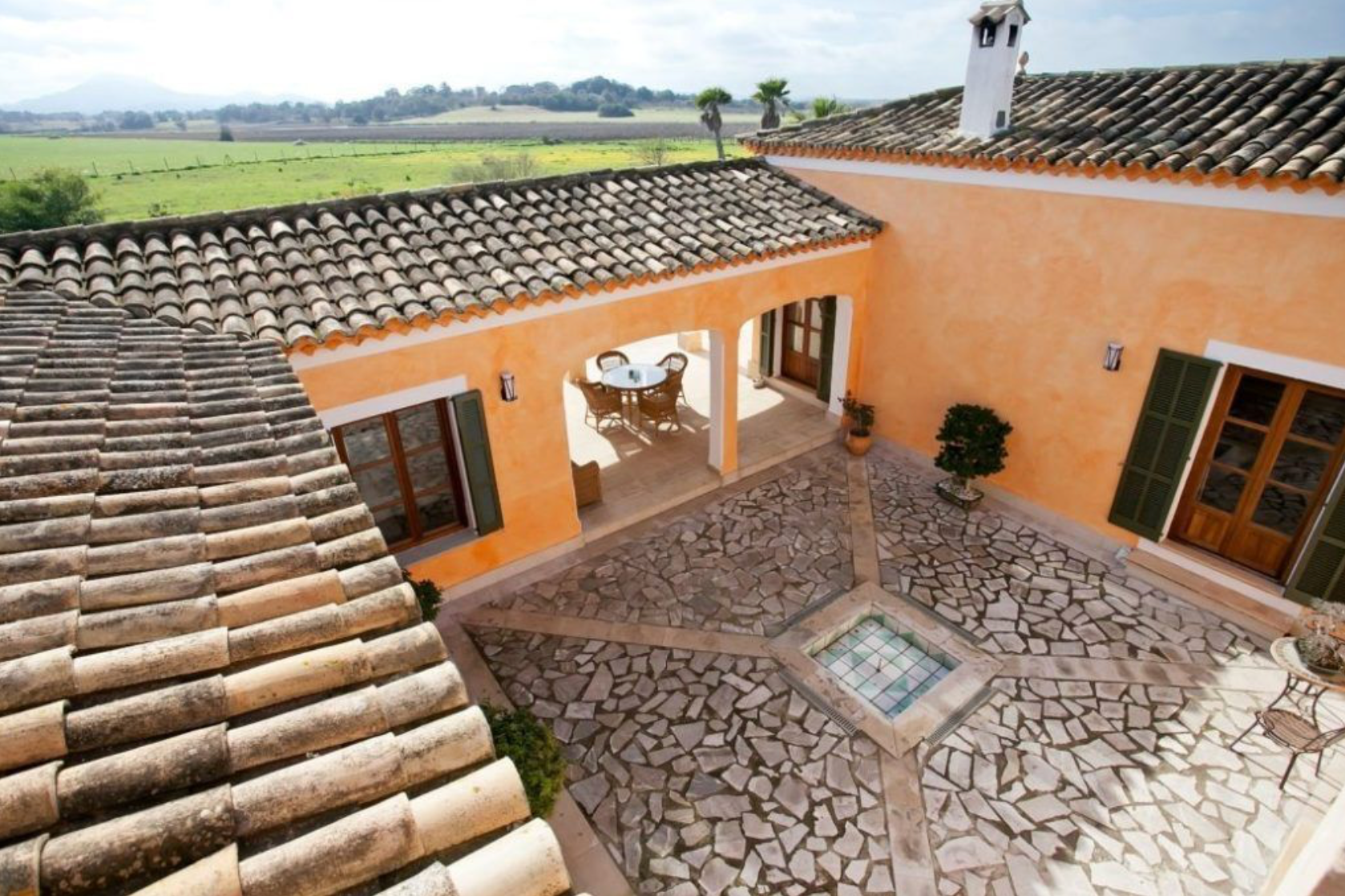 Rustic terracotta roof tiles and wooden beams create a traditional Mediterranean architectural pattern.