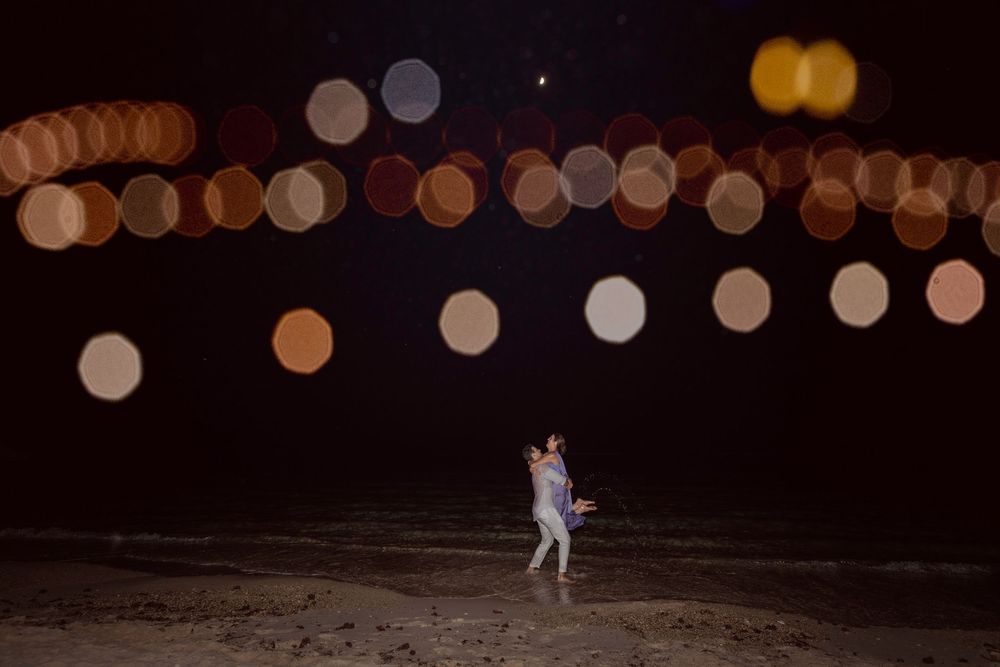 Blurred bokeh lights creating a warm glowing atmosphere at an evening outdoor event.