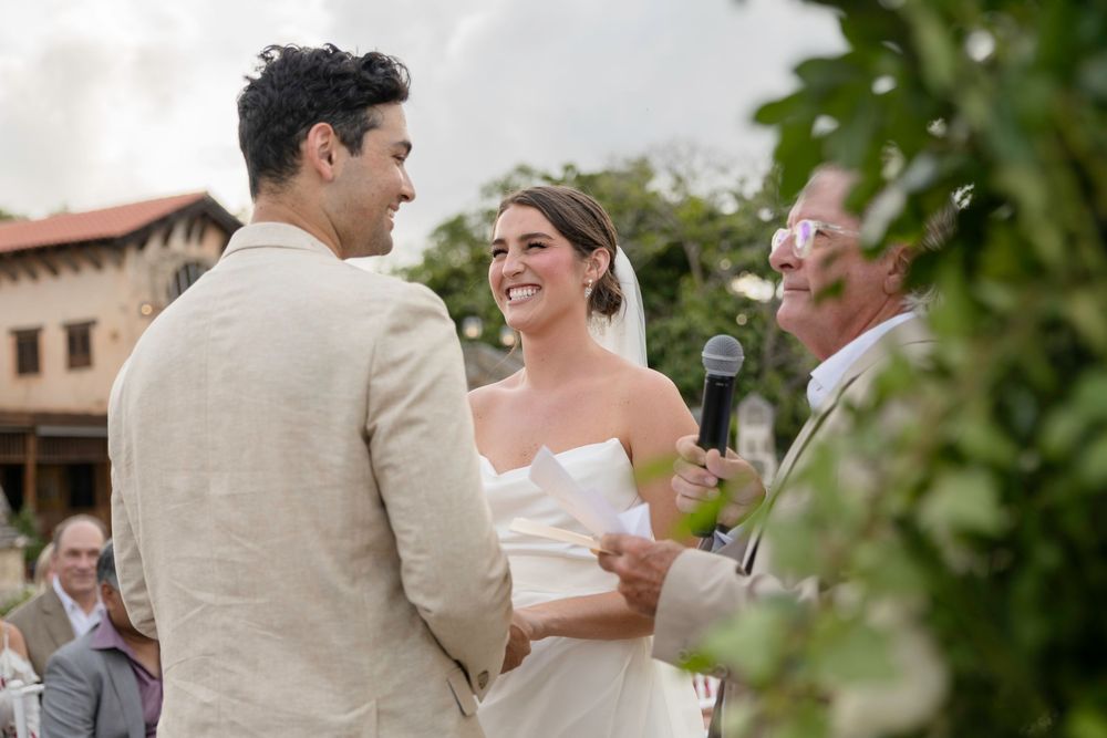 A couple shares a joyful dance together during an outdoor wedding reception.