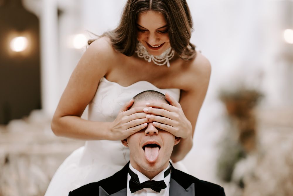 A collection of candid black and white wedding photos showing joyful moments between a couple on their special day.