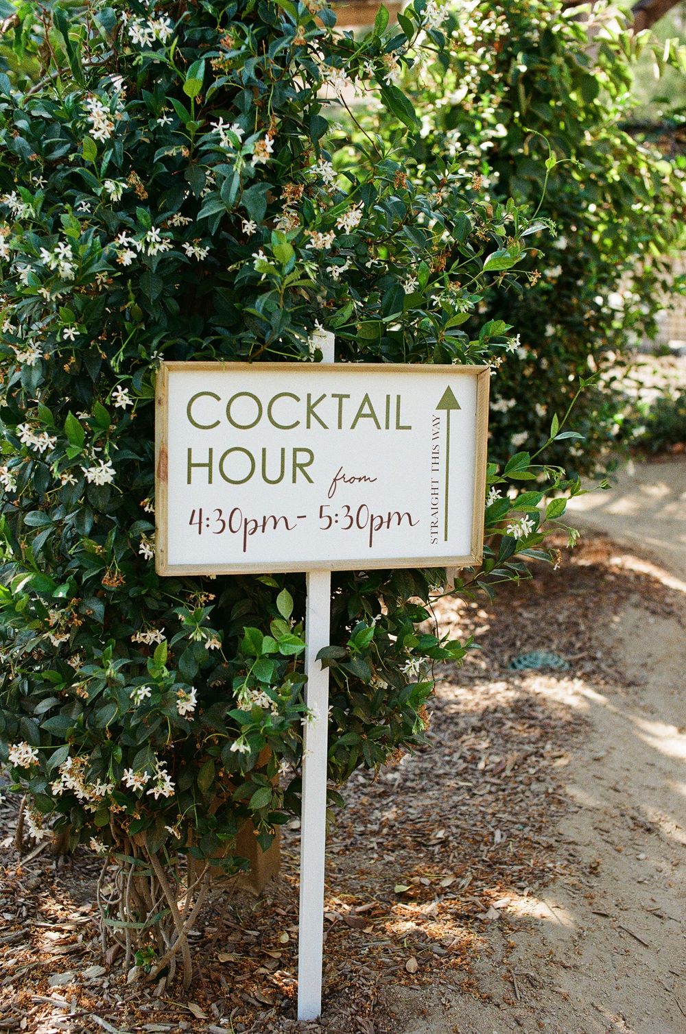 35mm film photo of the customized cocktail hour signage at a lush Orange County wedding venue.