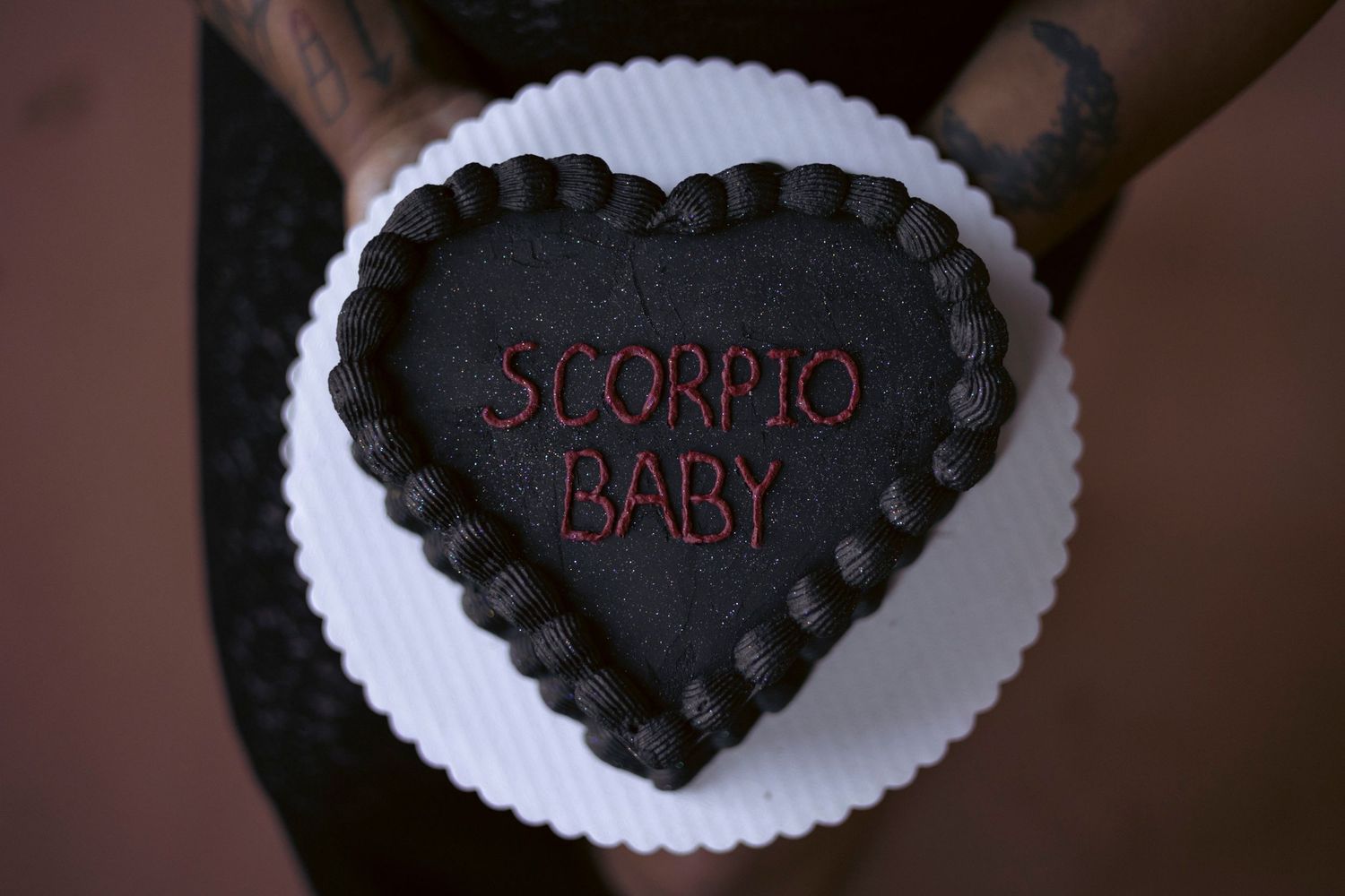 Dark chocolate truffles arranged on white paper doilies spell out romantic messages.