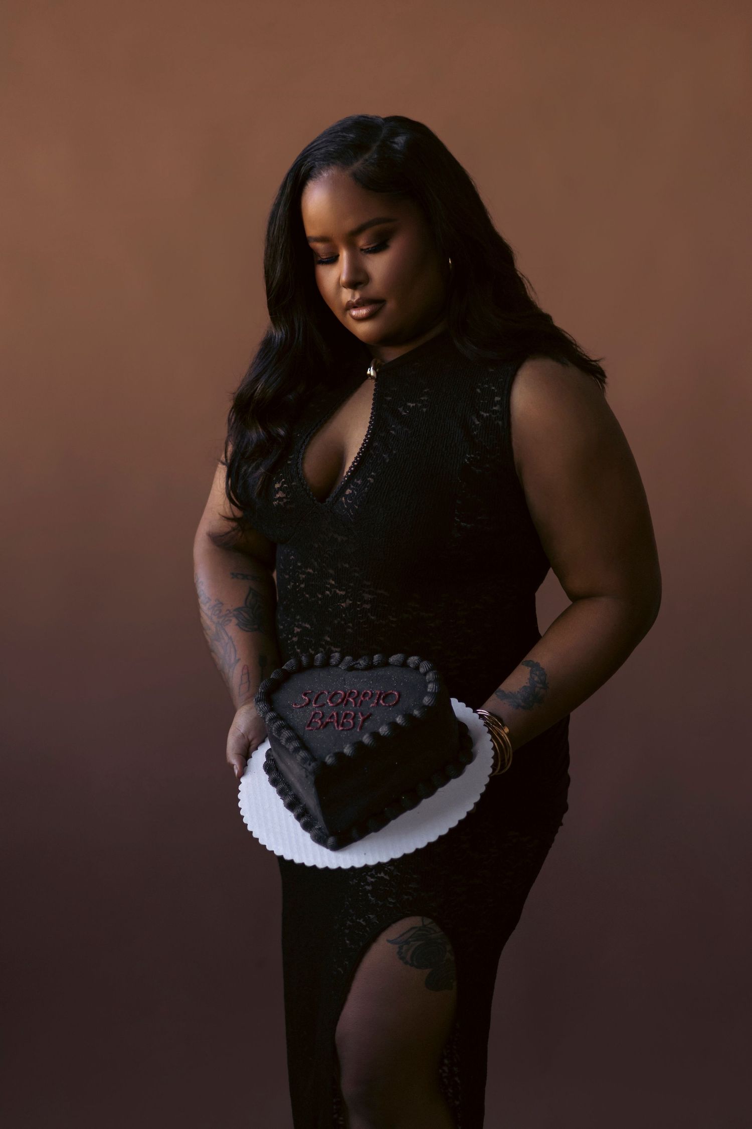 A series of artistic boudoir photos showing a plus-size model in black lingerie against a dark brown backdrop.