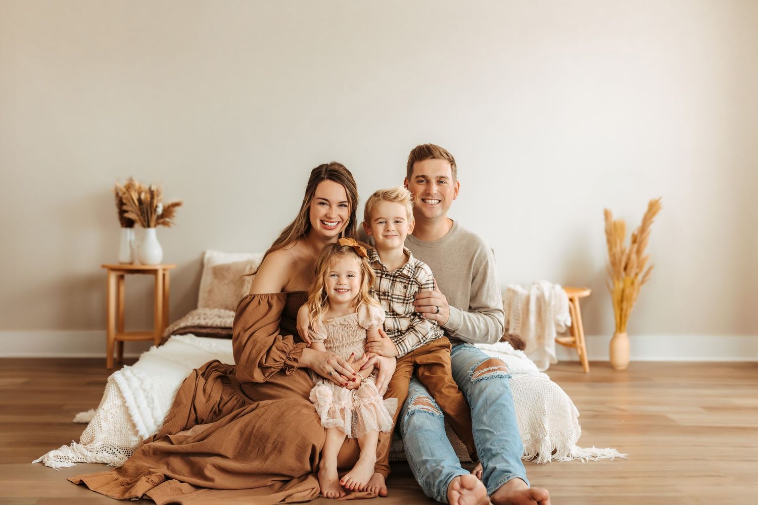 Family of four smiling together in a Maryville, TN studio family photoshoot