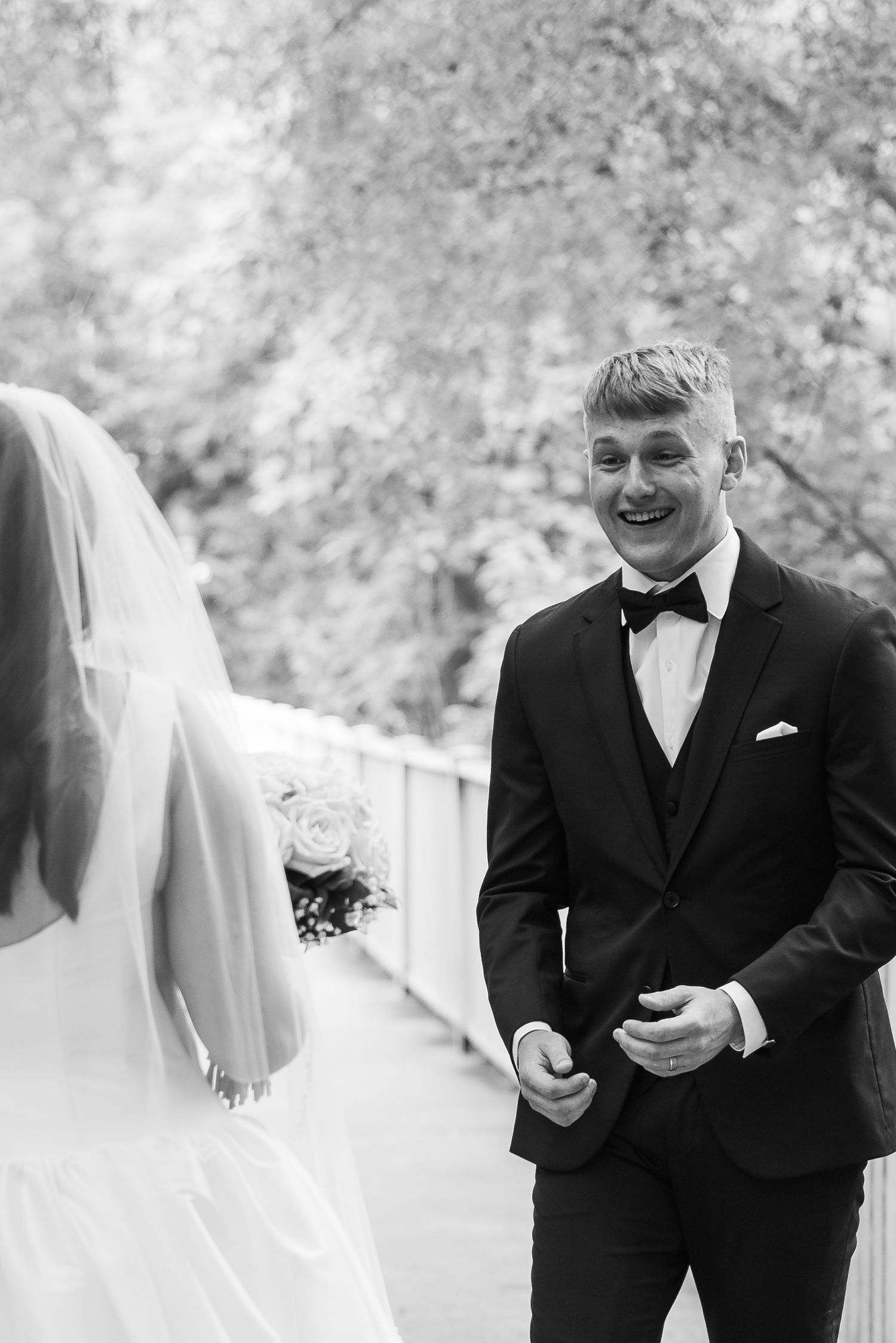 Black and white photo series showing emotional first look reactions between a bride and groom at an outdoor wedding.