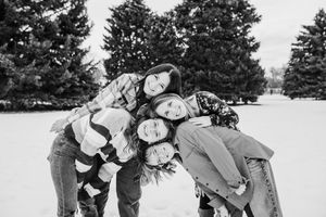 A series of black and white photos showing people playing in the snow and engaging in winter activities.