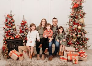 A series of holiday family photos with Christmas trees, presents, and festive red and gold decorations.