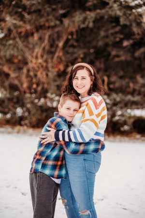 A winter outdoor photoshoot sequence showing a sweet embrace in the snow with warm earth-toned styling.