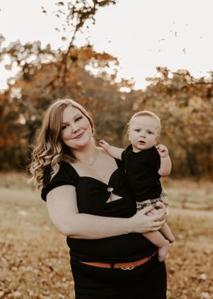 Candid family moments captured during a fall photoshoot with autumn colors in the background.