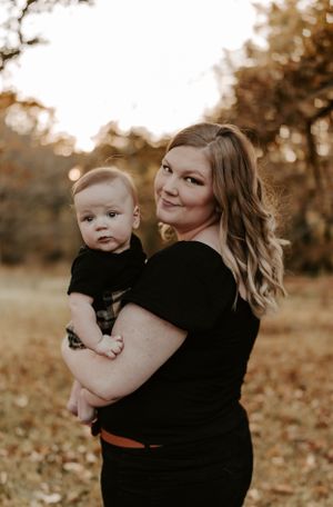 Family portraits showing tender moments between parent and baby against a golden autumn backdrop.