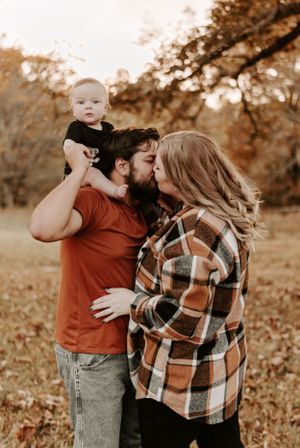 Intimate family moments captured in warm autumn tones with casual outdoor styling.