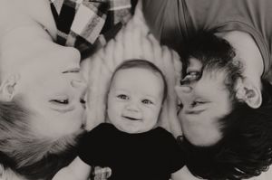 Black and white intimate family portrait series showing close connections and smiles.