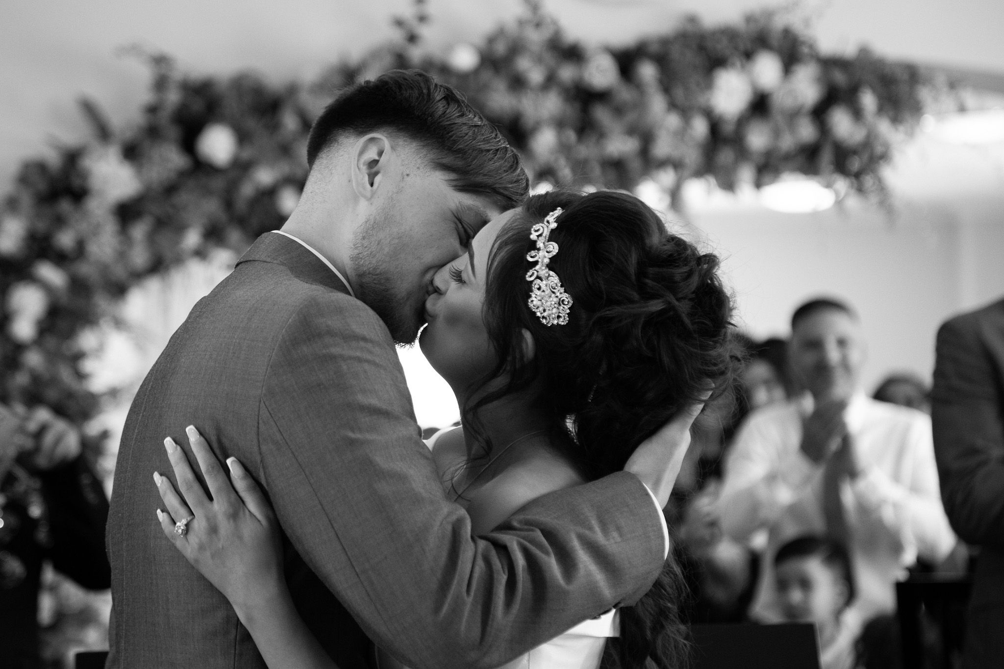 Couple sharing their first kiss in a black-and-white wedding photo at Sandwell Registry Office