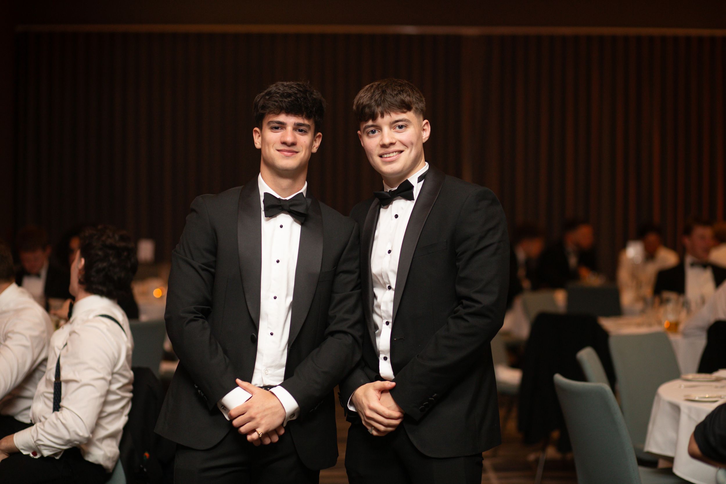 Posed photo of two students at a formal dinner at Edgbaston Park Hotel for a university sports team event.