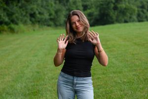 Candid shots of a woman in black top and jeans enjoying a summer day outdoors.