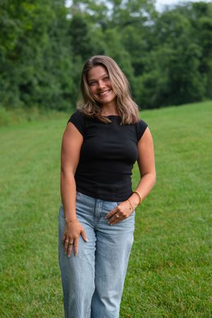 Casual lifestyle portraits taken in a grassy field with natural lighting.