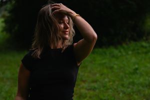 Artistic outdoor portrait shots with dramatic lighting in a natural setting.