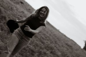 Black and white portraits of a woman posing against a natural backdrop.