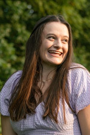 Woman in white lace dress laughing joyfully in a series of candid outdoor portrait shots.