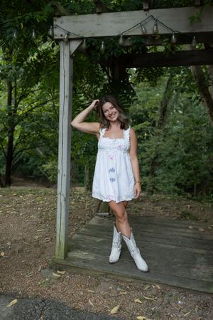 A series of candid shots showing a person in a white dress and sneakers posing on a wooden platform.
