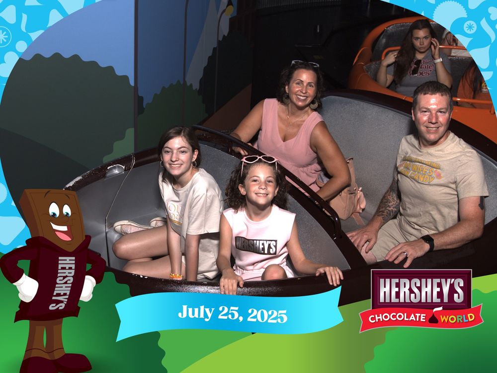 Multiple people enjoying rides and activities at an amusement park with a Hershey's theme on July 25, 2025.