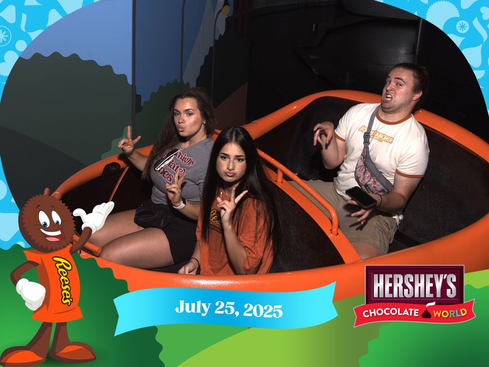 People having fun on a rollercoaster or thrill ride at a Hershey's themed amusement park.