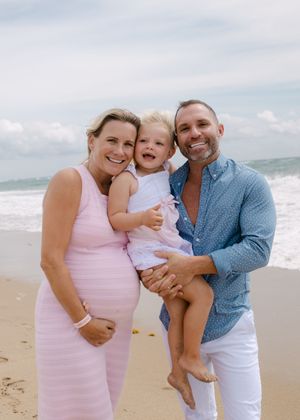 A joyful family photo session on a sunny beach.