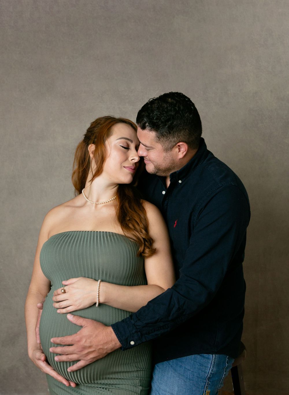 A maternity intimate moment between a couple in gray and olive tones. Orlando Maternity Photography, Sanford Maternity Photography
