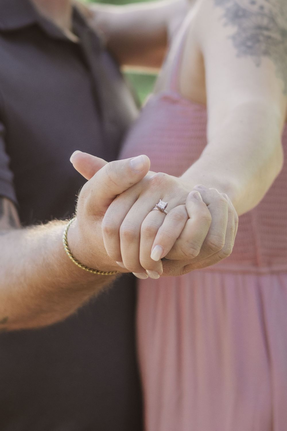 Close-up sequence showing hands clasping together in a romantic gesture.