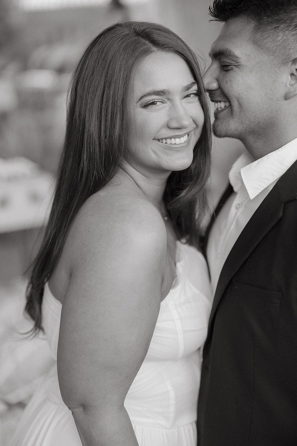 Black and white intimate wedding portrait series showing couple in romantic candid moments, smiling and embracing.