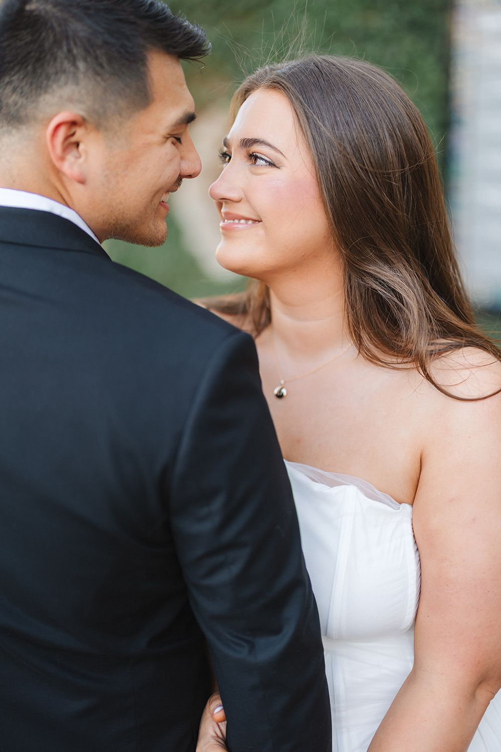Close up views of romantic couple sharing intimate moments outdoors while dressed in formal attire.