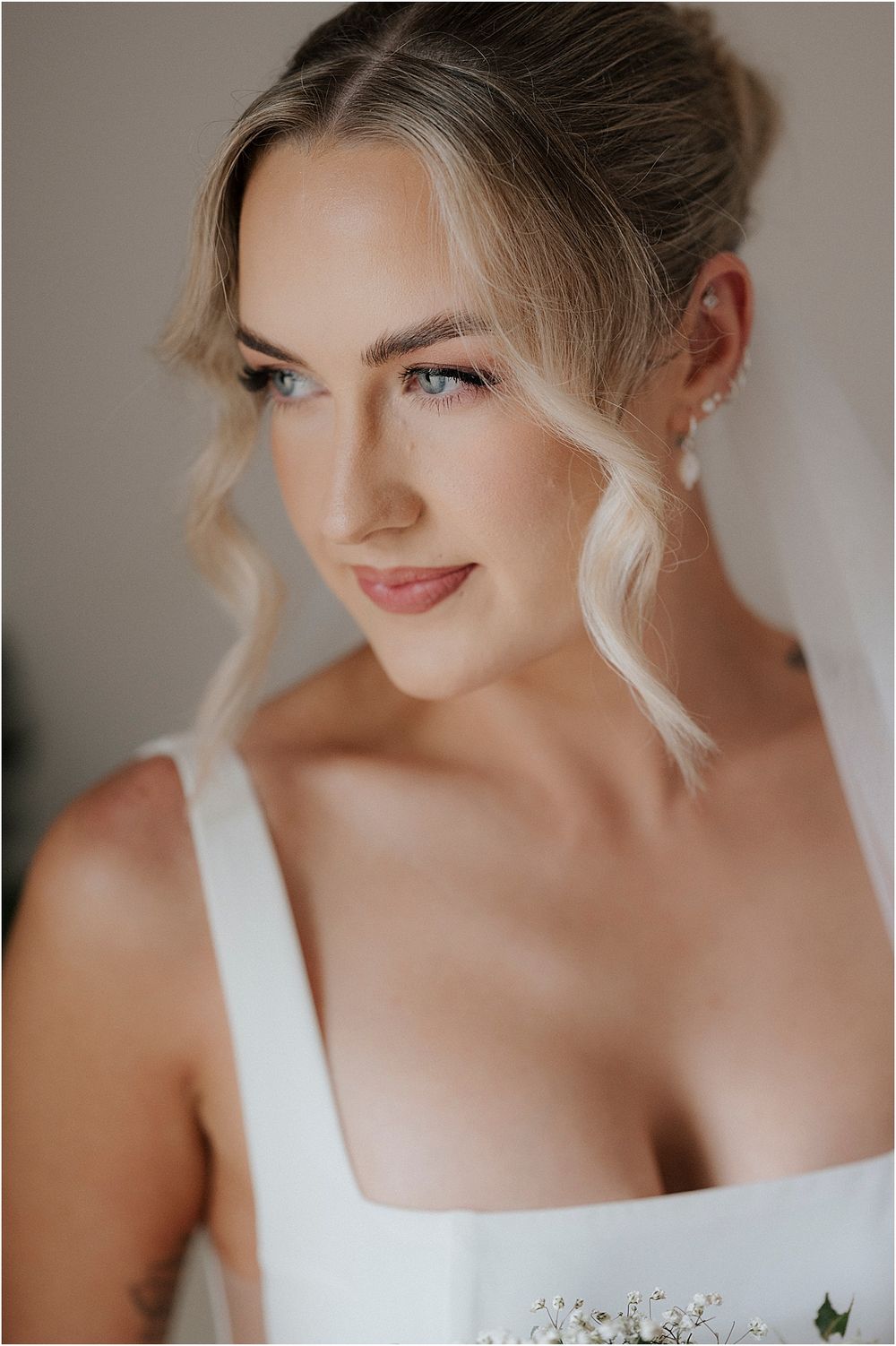 Classic bridal beauty portrait with elegant makeup and white dress.