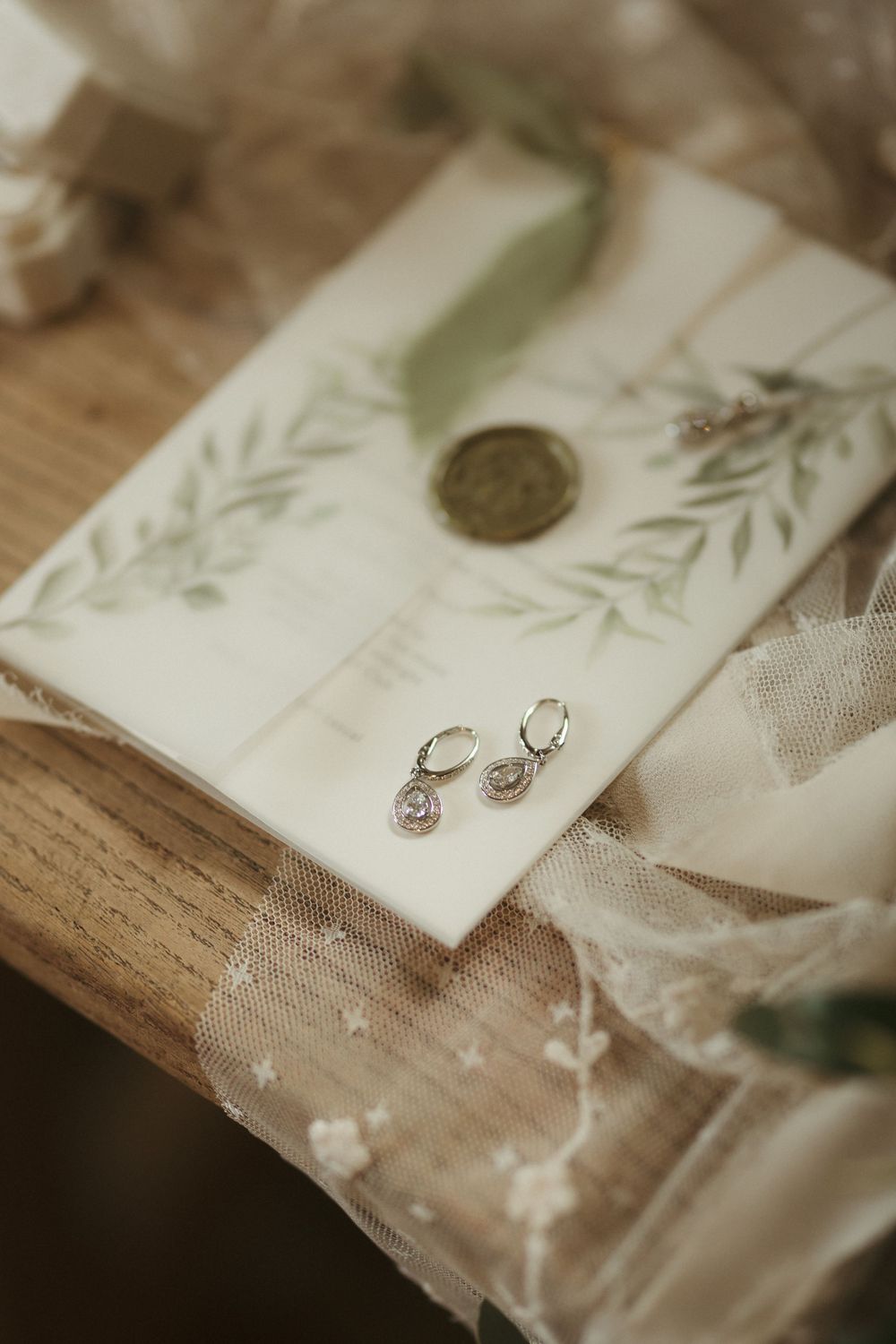 Five panels showing delicate decorative paper elements with floral designs and fabric details for wedding stationery.
