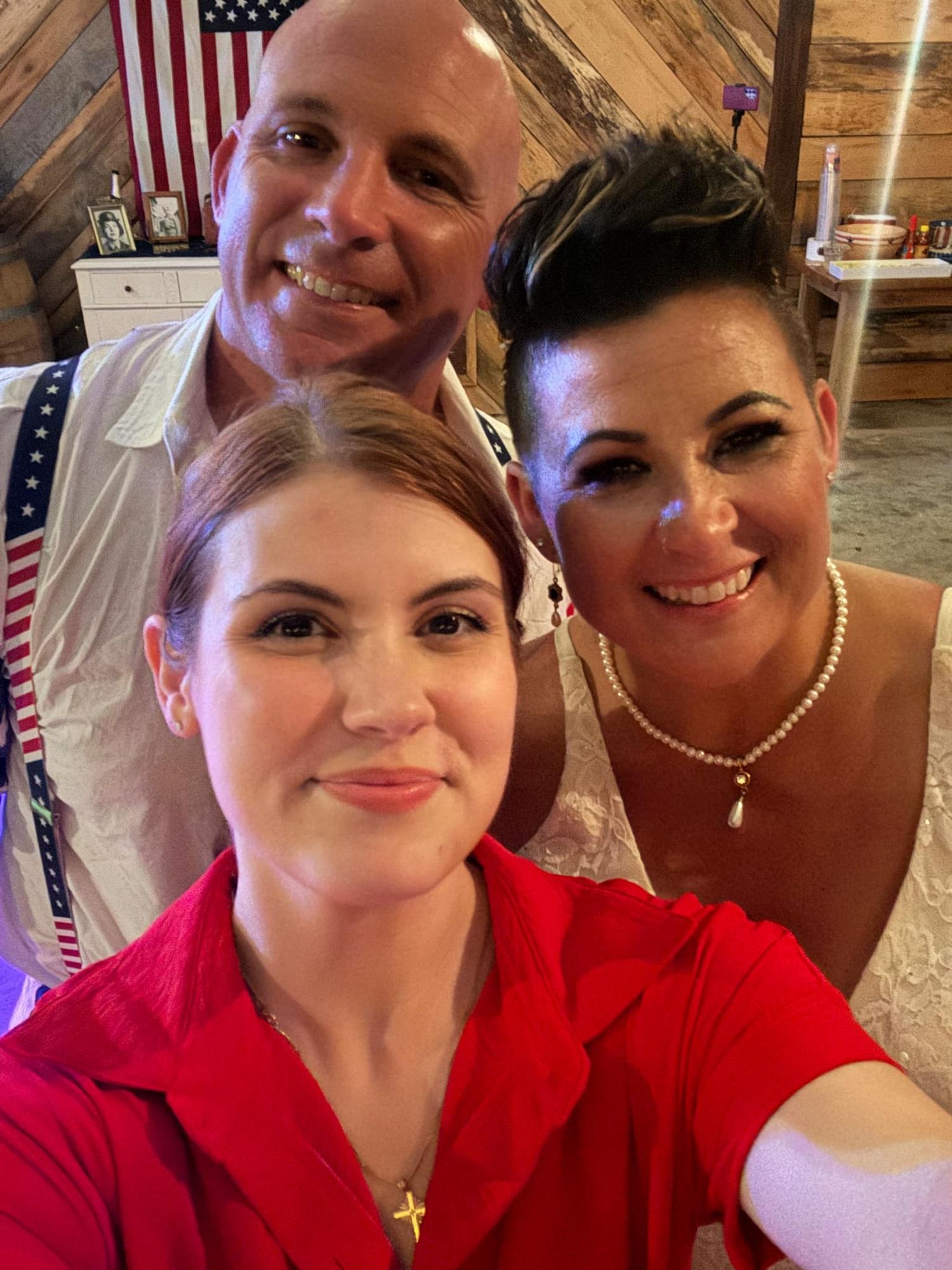 Interior party scene with American flag and rustic decor in background.