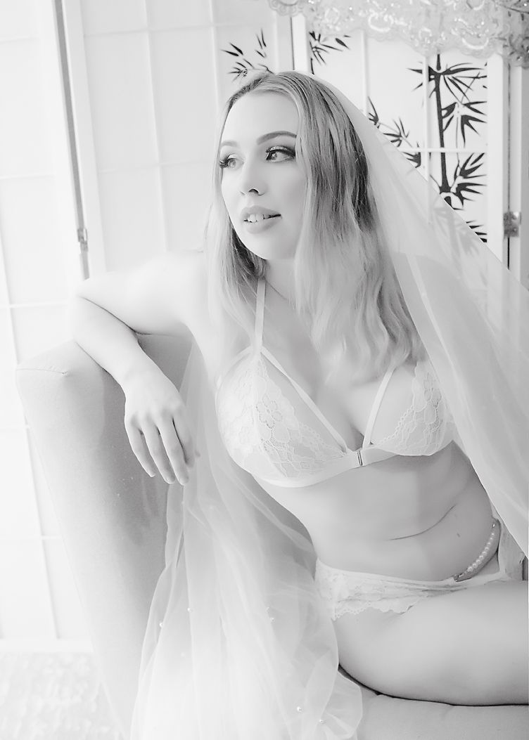 A series of artistic black and white portraits showing someone posing with flowing fabric in ethereal lighting.
