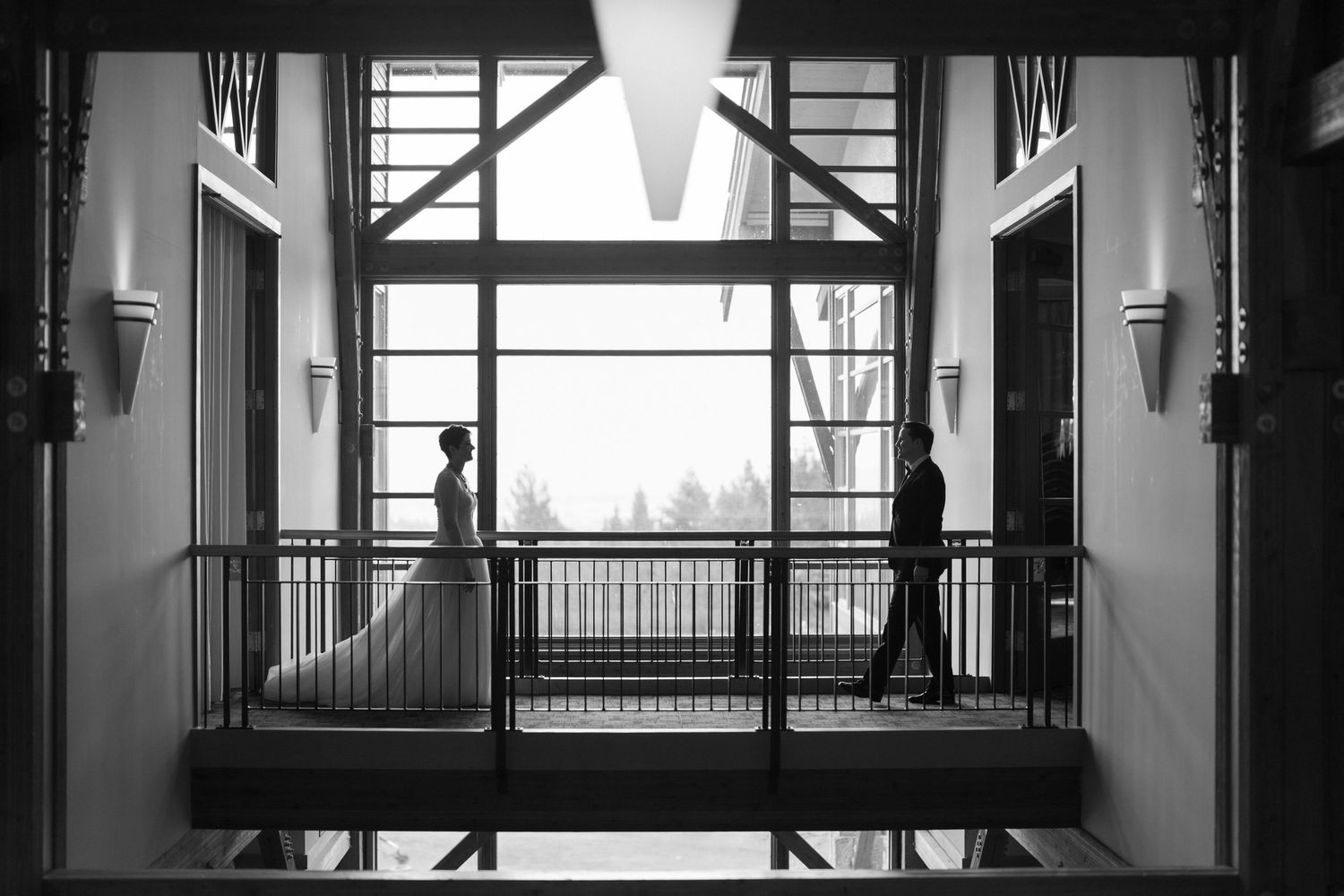 Black and white architectural photo of modern wedding venue interior with dramatic lighting.