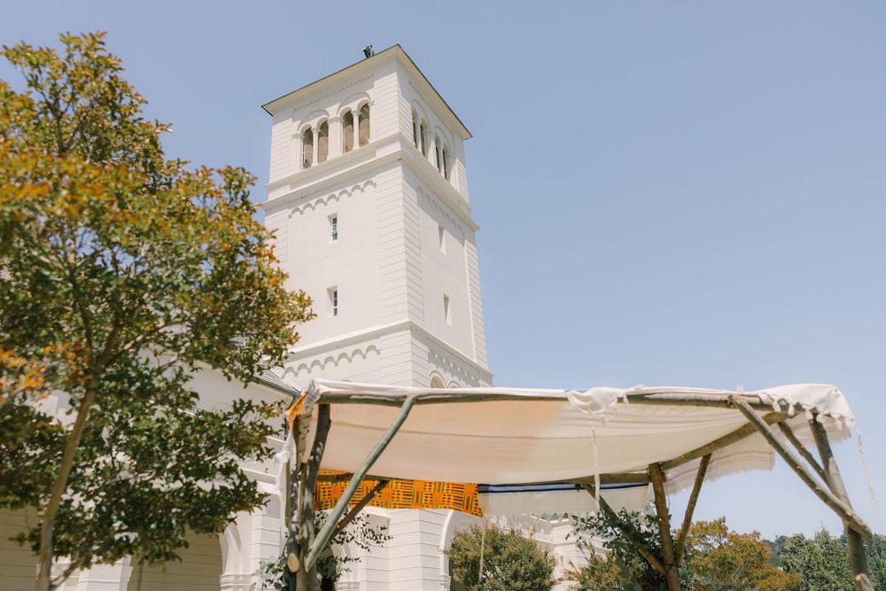View of the Geneva Terrace tower and yellow summer trees from the ceremony space on the Redlands University Marin Campus.