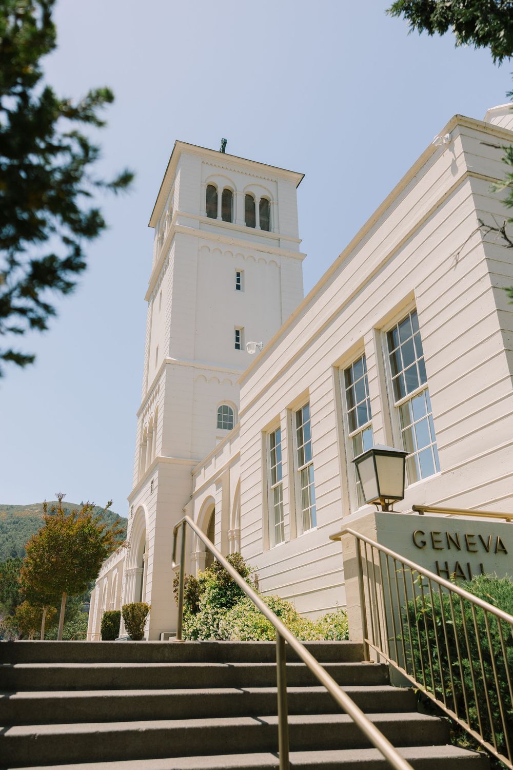 Front walkway and entrance to Geneva Terrace, part of the Redlands University Marin Campus, lined with trees and historic architecture.