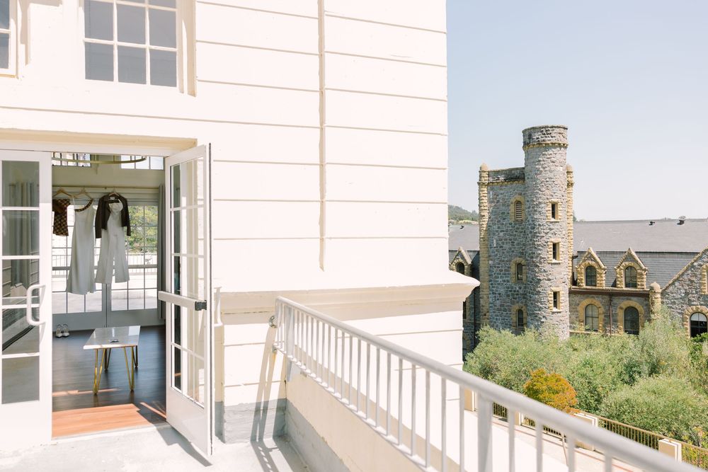 Exterior shot of Redlands University Marin Campus, showing the castle-like architecture and terrace walkway with brides dress.