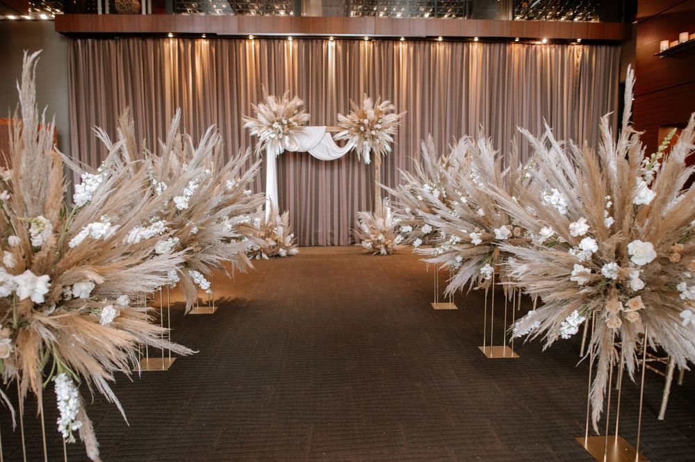 White crystal snowflake decorations hang from a ceiling at an elegant winter-themed event venue.