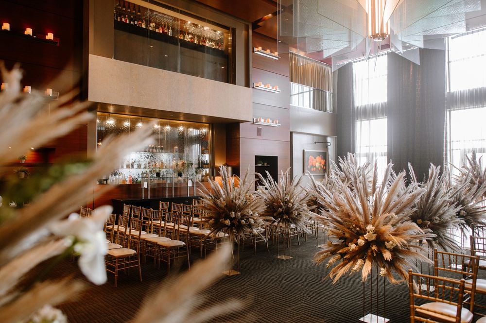 Modern restaurant interior with exposed ceiling, warm lighting, and contemporary pendant light fixtures creating ambiance.