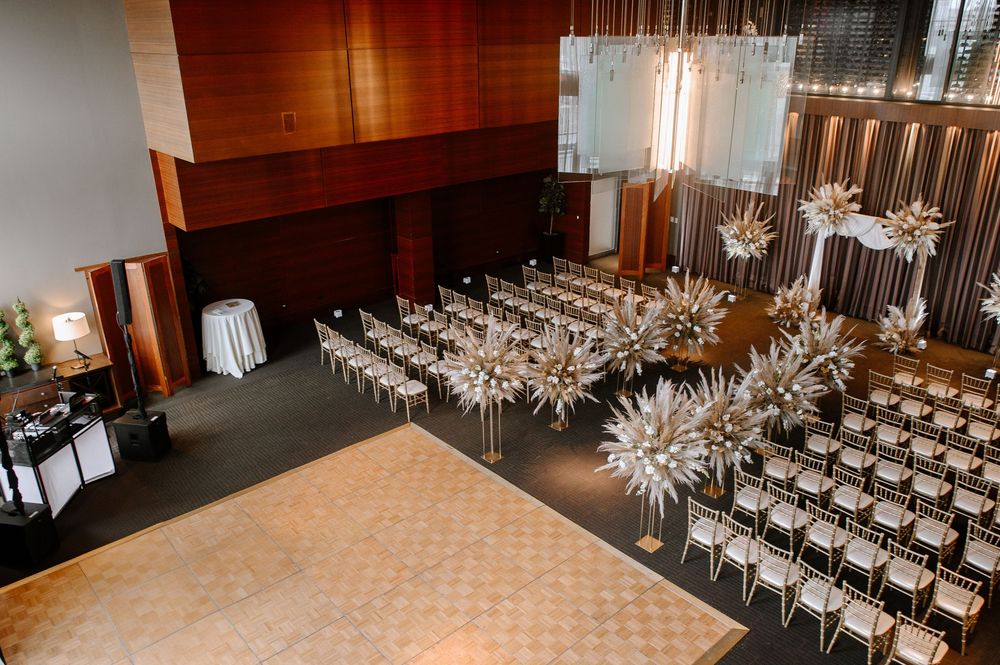 Contemporary banquet hall setup with sleek silver chairs and glittering starburst light fixtures creating an elegant atmosphere.