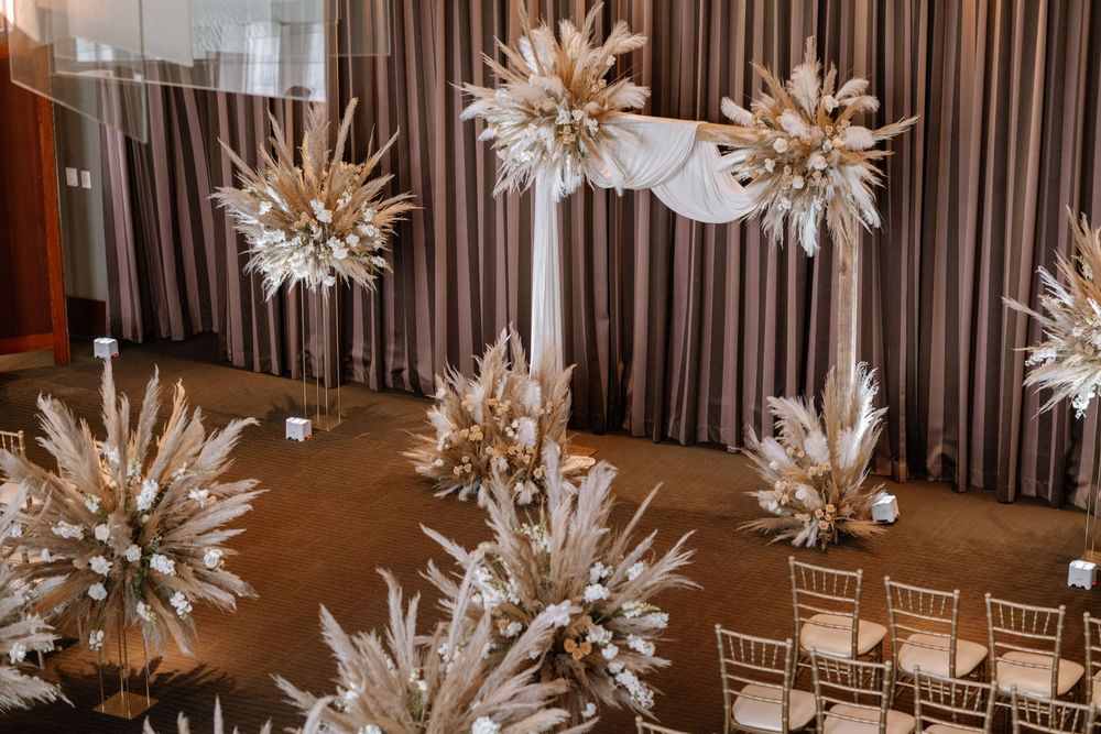 Elegant hanging paper star lanterns create a magical atmosphere at an indoor wedding reception venue.